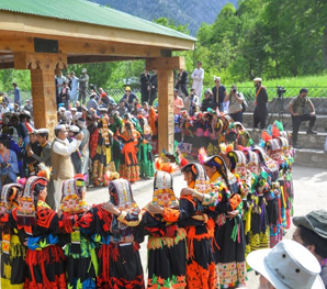 Kalash women in colorful traditional embroidered dresses performing a cultural dance during a Heritage and Culture Tour in Pakistan