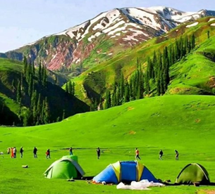 Camping tents on green mountain meadows in Kaghan Valley tour itinerary